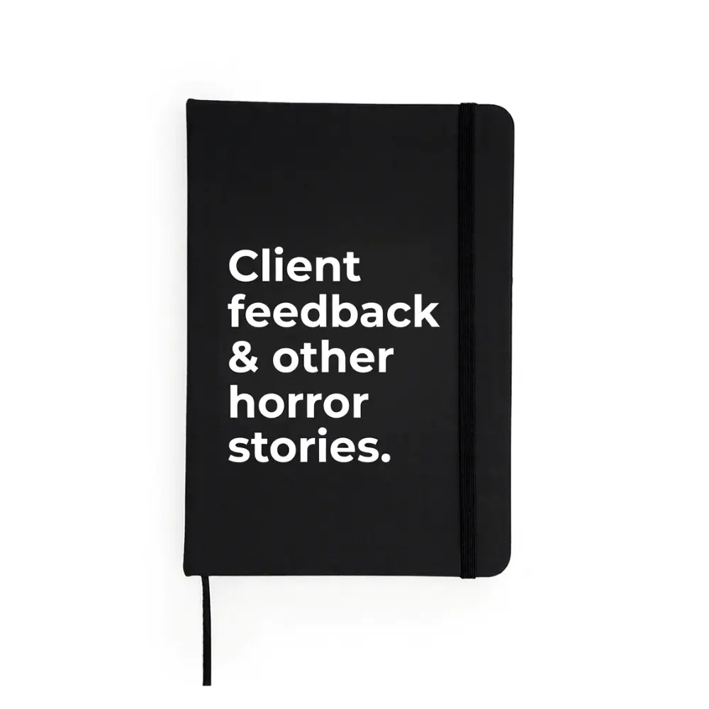 Agendă neagră cu mesaj „Client feedback & other horror stories.”